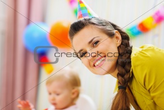 Portrait of happy mother at babies birthday party