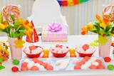 Closeup on table decorated for baby birthday party
