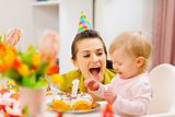 Mother and baby having fun at birthday party
