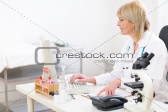 Senior doctor woman working on computer