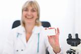 Doctor woman showing business card