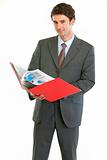 Modern business man checking documents in folder