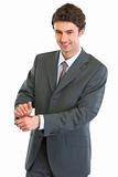 Modern business man showing tossed coin