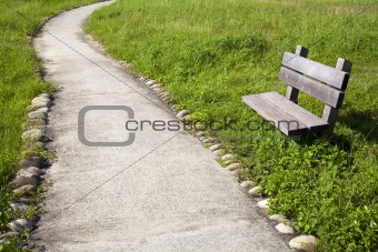 curved road with chair in the park