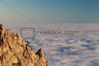 Evening rocks and sea in clouds