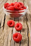 Fresh healthy organic raspberry on wooden background