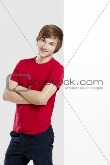 Portrait of a happy young man next to a blank white card