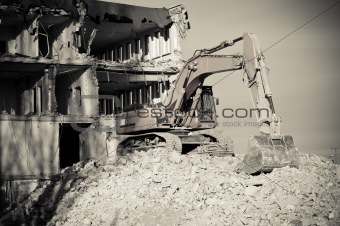 digger working during the demolition of the building
