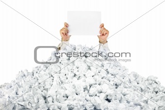Person under crumpled pile of papers with a blank page / isolate