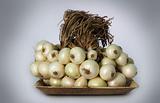 Bunch of white onions(allium cepa) on a plate 