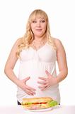 Emotional pregnant woman with huge sandwich