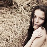 girl next to haystack