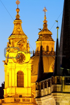 prague - different architectural styles-st. nicolas church and charles bridge tower
