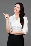 Business woman pointing at copyspace