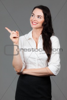 Business woman pointing at copyspace