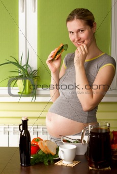 Pregnant Woman On Kitchen