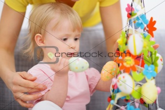 Mom helping baby made Easter decoration