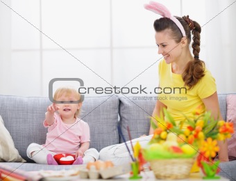 Mother and baby making preparations for Easter