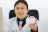 Closeup on business card in hand of medical doctor