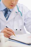 Closeup of medical doctor working with documents