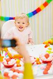 Mother making photos of baby on birthday party