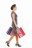 Woman in dress walking with shopping bags