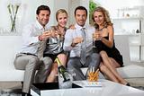 Two couples drinking champagne at home
