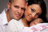 Happy Young Attractive Mixed Race Family with Newborn Baby.