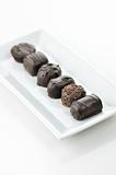 chocolate candies assortment in a white plate