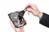 Cleaning open hard disk with brush. On a white background.