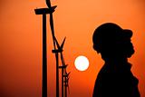 The Silhouette of windmills worker with  sunset