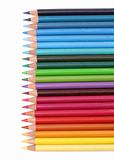 Color pencils over white background