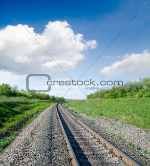 railway goes to horizon in green landscape
