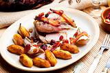 baked pheasant with bacon, pear, raisins on brandy