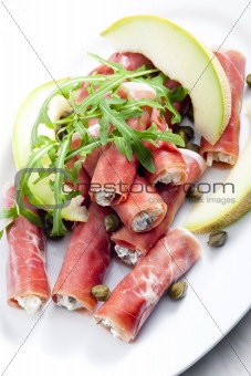 Parma ham rolls filled with cream cheese, Galia melon and capers