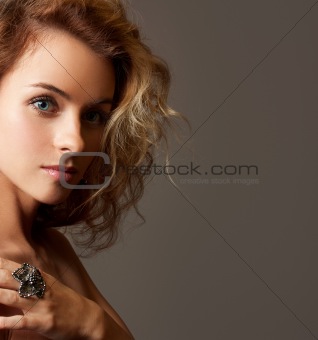 Beautiful Young Woman Face. Close-up studio portrait with copy-space.
