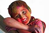 Close up face of young boy playing Holi, smiling colors, white B