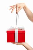 hand holding ribbon and open gift box