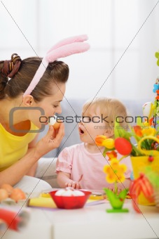 Mother and baby eating Easter egg