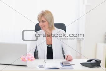 Middle age business woman working at office