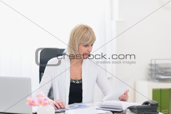 Middle age business woman working with documents
