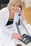 Smiling middle age business woman making phone call