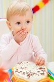 Portrait of eat smeared kid eating cake