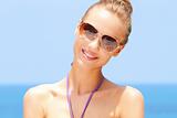 Pretty woman at the beach with sunglasses
