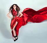 flexible girl moves in a red long dress