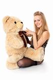 girl plays with stuffed bear