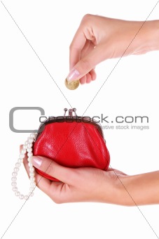 Red wallet and coin in womans hand