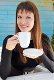 girl holding a cup of drink and smiled pleasantly
