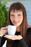 girl holding a cup of tea and smiled pleasantly