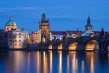 czech republic, prague - charles bridge and spires of the old town at dusk